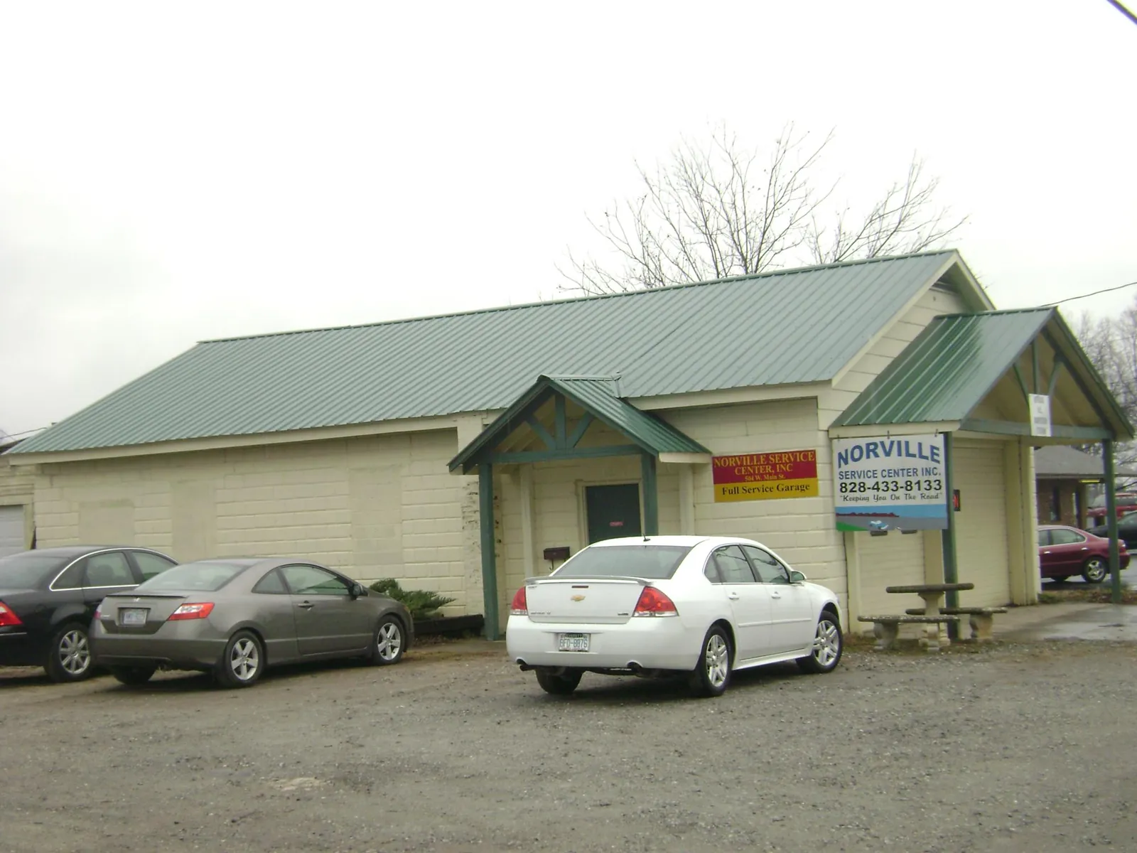 Green metal roof on a service garage with a covered entry in Waverly